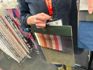 a person holding a fabrics board